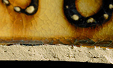 North Midlands slip decorated handled cup.&nbsp;Interior decorated with &ldquo;jeweled&rdquo; dots of slip typical of late 17th- and early 18th-century vessels. Decorated in white and brown slip, Glazed interior (left) and exterior (middle). Base diameter:&nbsp;5.75&rdquo; Lot 229. Paste shot shown on right - from 18CV169. 