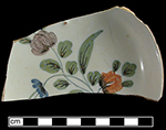 Fazackerly style decoration incorporates floral motifs in a distinctive palette that includes sage green, lemon yellow, strong reds, purples and blues.