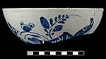 Punchbowl painted in blue with floral sprays and bird sitting on a fence.