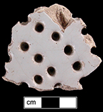 Tin glaze fish drainer or colander bowl sherd, undecorated with drainage holes piercing vessel (left) - see whole example on right from private collection.Colanders and fish drainers depicted in printed sources generally date to the second half of the 18th century.