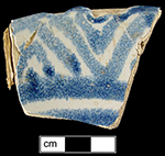 Dish painted with geometric rim design.