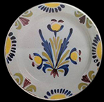 Plate painted with swag design in red and blue (left) -  This vessel is very similar to a number of vessels illustrated in Archer (1997: Plates 59-64) that are dated to the third quarter of the 18th century and manufactured at Lambeth. (example on right).