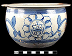 Pearlware scratch blue chamberpot with GR sprig molded medallion. Rim diameter:  8.12&rdquo;, Base diameter: 4.50&rdquo;, Vessel height: 4.50&rdquo;. Lot: 9, Provenience:1G3.886.106, Privy Stratum 2 - 18BC38