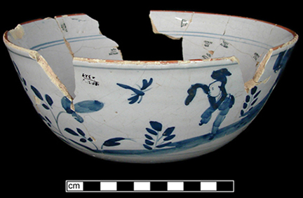 Reconstructed bowl with Chinoiserie design, painted in blue with Chinese style landscape and figure,&nbsp;and red rim line. Chinese landscapes on tin glaze most predominant 1720s-c 1780, with peak production circa 1750. Red rim lines date between 1730s to 1790s with highest occurrence in 1730s and 1740s.