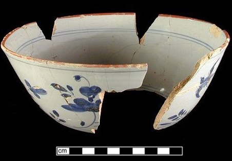Reconstructed bowl with Chinoiserie design, painted in blue with Chinese style landscape and figure,&nbsp;and red rim line. Chinese landscapes on tin glaze most predominant 1720s-c 1780, with peak production circa 1750. Red rim lines date between 1730s to 1790s with highest occurrence in 1730s and 1740s.