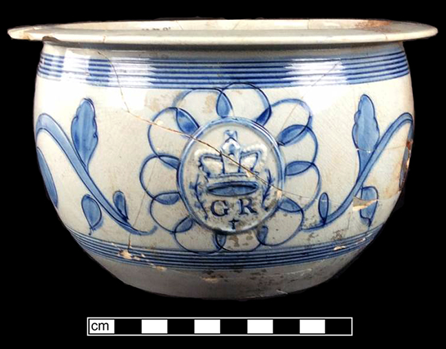 Pearlware scratch blue chamberpot with GR sprig molded medallion. Rim diameter:  8.12&rdquo;, Base diameter: 4.50&rdquo;, Vessel height: 4.50&rdquo;. Lot: ? - 18BC38