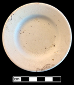 Butter pat?, rolled rim. Unglazed bisque waster. Rim diameter: 3.25”; 4.9 mm thick.