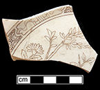 Plate. Unglazed bisque waster. Transfer printed  floral motif in brown. 4.6 mm thick