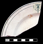 Plate, rolled rim. Unglazed bisque waster. Painted green band and line with decal motif. Rim diameter:7.25� 4.0 mm thick.