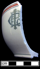 Cup with painted band and line decoration and decal motif “I P Co”? Rim diameter: 3/50”; Vessel height: 2/50”; 5.8 mm thick.