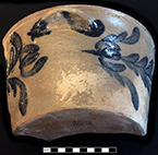 Grey bodied salt glaze stoneware bowl with cobalt floral decoration. Cupped lug handle. Vessel rim diameter: 12.00”, Vessel height: 5.50”.