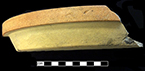 North American buff bodied stoneware molded pie pan.  Unglazed exterior, Albany slipped interior. Made in a jigger mold. Base of vessel has impressed/molded lettering that reads “Discoloration or Soaking of Crust”, Rim diameter:  10.00”, Vessel height:  1.50”, from 18CV13.
