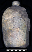 Grey bodied salt glaze stoneware jug with missing handle. Vessel height: 9.50”, Vessel body diameter: approximately 4.50”, Vessel V-27 from 18MO609.