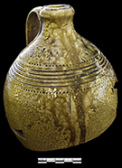 North Carolina Piedmont salt glazed stoneware jug with rouletting, incised bands and incised W. N. Craven mark. According to North Carolina potter Hal Pugh, this vessel appeared to have been salt glazed, but the runny portions of the glaze are from ash dripping in the kiln, creating an alkaline glaze (Hatch et al. 2017).