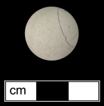 Limestone marble. Although produced as early as 16th century in Europe, importation of limestone marbles to North America really didn’t begin until after 1769 (Gartley and Carskadden 1998:93).  Since occupation at this site dated circa 1711-1749, this artifact represents  an early example of a limestone marble in the American colonies - click on image to see larger view.