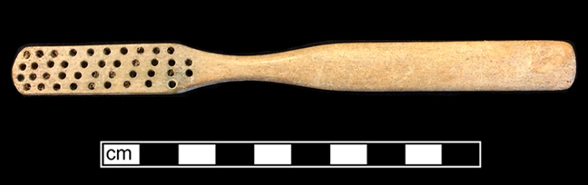 Bone handled toothbrush with gradual neck. Rounded square stock, handle has flat oval cross section; rounded base, with wire drawn bristle attachment. 1G.448.12 18BC38