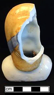 Painted hard paste porcelain Bonnet doll. Bonnet dolls mostly date from after 1885 (King 1981:306).&nbsp;This porcelain head would have been attached to a cloth body and would have had porcelain arms and legs. A similar doll shown on right made by the Hertwig Company (1864-1941), Germany, circa 1900 - from 18BC27.