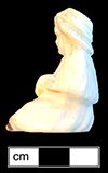 Small sitting doll, made of bisque porcelain, with the legs broken off. 4.75cm x 2.75cm x 3cm, from 18BC27.