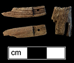 These are part of a wooden peg or Grodnerthal doll. The portion on the right is a torso, with slots where the legs attached and the pieces on the left are probably legs from 18BC27, Feature 30.  Grodnerthal dolls were first imported to England from Amsterdam in the early 19th century. Earlier peg dolls had layers of gesso on portions of the body not covered by clothing and were painted facial features and shoes.  Later in the century, the quality deteriorated, with gesso layers omitted and less detailed carving. http://www.miniphile.com/Pages/Vic-dolls.htm