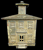 The front of a cast iron toy bank. 8cm x 8cm. See example on right from private collection. The top and bottom parts were screwed into place (N/A 2017). Height: 5.75”, from 18BC27.