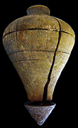 Wooden peg top with traces of an iron tip. Wooden tops were often made of boxwood or lignum vitae. Antique example below shows what the iron tip may have looked like. The Federal Reserve top is missing the top rivet, which was sometimes made of brass. The 1895 Montgomery Ward catalog offered five models of tops of differing hardwoods and sizes, from 18BC27. 