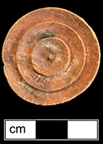 Checker game piece made of wood.  1.25" diameter, .25" tall, 3 concentric circles on both sides - from 18BC27, Feature 28.